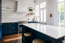 blue kitchen renovation floating shelves
