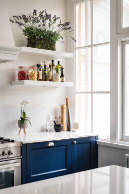 blue kitchen renovation floating shelves